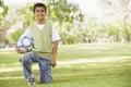 Boy in park holding football