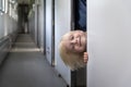 Boy peeks out of compartment carriage. Long trip with child on the train