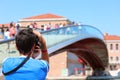 Young Boy photographs the modern bridge called Ponte della Costi