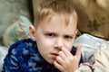 The boy picks his nose. Snot, runny nose in a child Royalty Free Stock Photo
