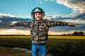 A boy in a pilot`s helmet on a sunset background. Dream concept, choice of profession, game. Copy space Royalty Free Stock Photo