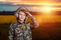 A boy in a pilot`s helmet on a sunset background. Dream concept, choice of profession, game. Copy space Royalty Free Stock Photo