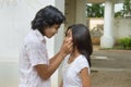 Boy pinching girl's cheeks