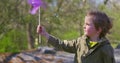 Child Holding Purple Pinwheel Outdoors