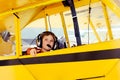 Boy in Piper Cub airplane wearing headset Royalty Free Stock Photo