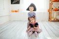 Boy in a pirate costume and a girl in a witch costume celebrates Halloween at home Royalty Free Stock Photo