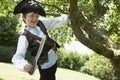 Boy In Pirate Costume Swinging From Tree Royalty Free Stock Photo