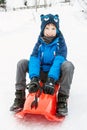 A boy on the plastic sledge Royalty Free Stock Photo