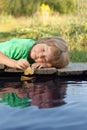 Boy play with autumn leaf ship in water, chidren in park play wi Royalty Free Stock Photo