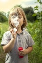 Boy play in bubbles in sunny summer day