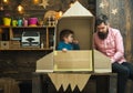 Boy play with dad, father, little cosmonaut sit in rocket made out of cardboard box. Rocket launch concept. Child cute