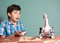 Boy play with dinosaur toy by remote control pult Royalty Free Stock Photo