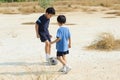 Boy play football on the dry soil ground Royalty Free Stock Photo