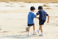 Boy play football on the dry soil ground Royalty Free Stock Photo