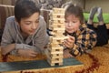 Boy play Jenga game together. children playing at home intrerior.