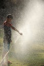 Boy play with jets of water Royalty Free Stock Photo