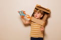 Boy play with paper rocket wears cardboard helmet space dreaming Royalty Free Stock Photo