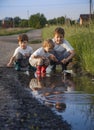 3 boy play in puddle summer day Royalty Free Stock Photo
