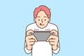 Boy play video game on mobile phone