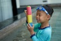 Boy play water gun with goggles in hotel vacation concept Royalty Free Stock Photo