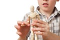Boy is played by wooden little manikin Royalty Free Stock Photo