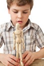 Boy is played by wooden little manikin Royalty Free Stock Photo