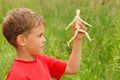 Boy is played by wooden little manikin Royalty Free Stock Photo