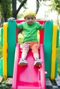 Boy on playground slide Royalty Free Stock Photo