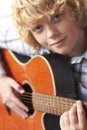 Boy Playing Acoustic Guitar Royalty Free Stock Photo