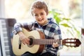 Boy playing acoustic guitar