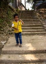 A boy playing alone on the stairways.
