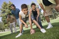 Boy Playing American Football With Group Of Men Royalty Free Stock Photo