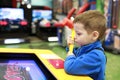 Boy playing arcade game with hammer Royalty Free Stock Photo