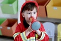 Boy playing as fireman police occupation in kindergarten class, kid occupation, education concept Royalty Free Stock Photo