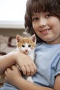 Boy playing with baby cat. Child and kitten at home Royalty Free Stock Photo