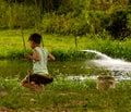 A boy playing on a balance near a lake Royalty Free Stock Photo