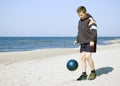 Boy playing ball on beach. Royalty Free Stock Photo