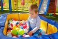 Boy is playing in the ball pool in the children`s playroom Royalty Free Stock Photo