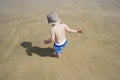 Boy (3-4) playing on beach back view Royalty Free Stock Photo