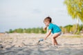 Boy playing on beach. Child play at sea on summer family vacation. Sand and water toys, sun protection for young child. Little boy Royalty Free Stock Photo