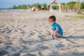 Boy playing on beach. Child play at sea on summer family vacation. Sand and water toys, sun protection for young child. Little boy Royalty Free Stock Photo