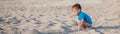 Boy playing on beach. Child play at sea on summer family vacation. Sand and water toys, sun protection for young child. Little boy Royalty Free Stock Photo