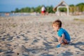 Boy playing on beach. Child play at sea on summer family vacation. Sand and water toys, sun protection for young child. Little boy Royalty Free Stock Photo