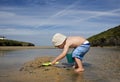 Boy (3-4) playing on beach back view Royalty Free Stock Photo
