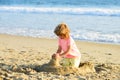 Boy playing on the beach on summer holidays. Children building a sandcastle at sea. Royalty Free Stock Photo