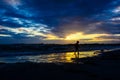 Boy playing on the beach at sunset Royalty Free Stock Photo