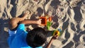 A boy playing with beach toys