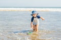 Boy playing on the beach in the water Royalty Free Stock Photo