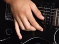 Boy playing black guitar