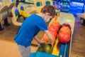 Boy playing bowling with medical masks during COVID-19 coronavirus in bowling club Royalty Free Stock Photo